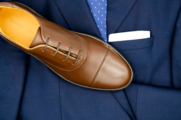 brown oxfords dress shoes with a blue suit