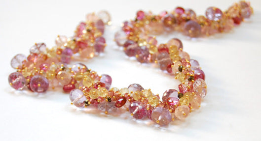 Pink sapphire, tourmaline, yellow sapphire, amethyst and topaz being linked together to form the necklace by Amy Holton Designs.