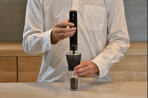 Barista using the Smart G Electric coffee grinder