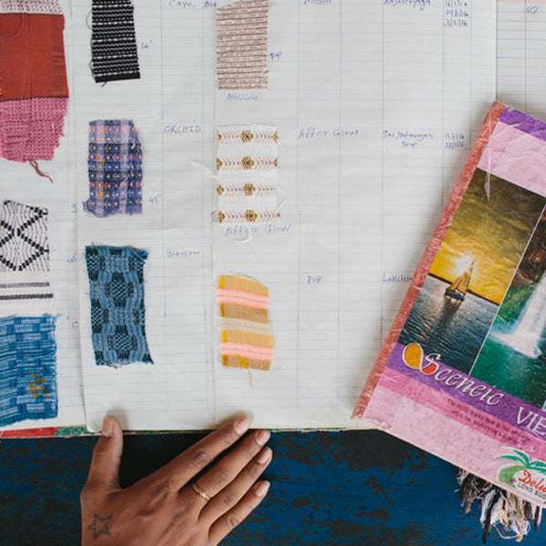 photo of hand next to a swatch book