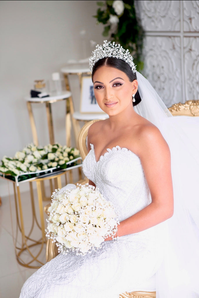 Georgette in her wedding ensemble wearing our Katrina Crown holding her bouquet