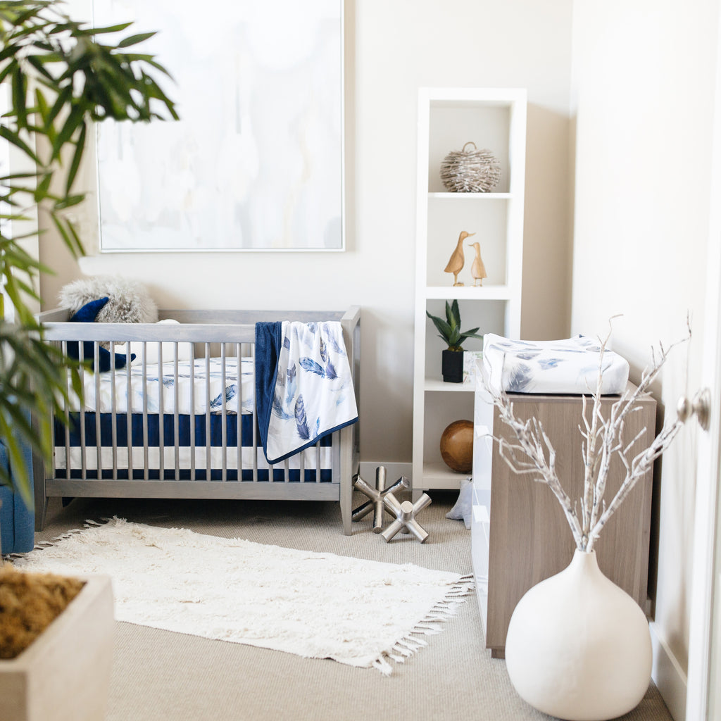 navy and gray nursery with feather nursery bedding