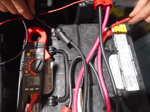 Checking voltage on floor scrubber battery pack using a volt meter.