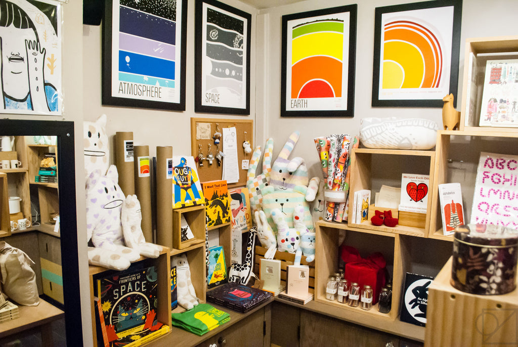 A wide shot look at our back room selection of prints, books, and accessories for children and adults alike