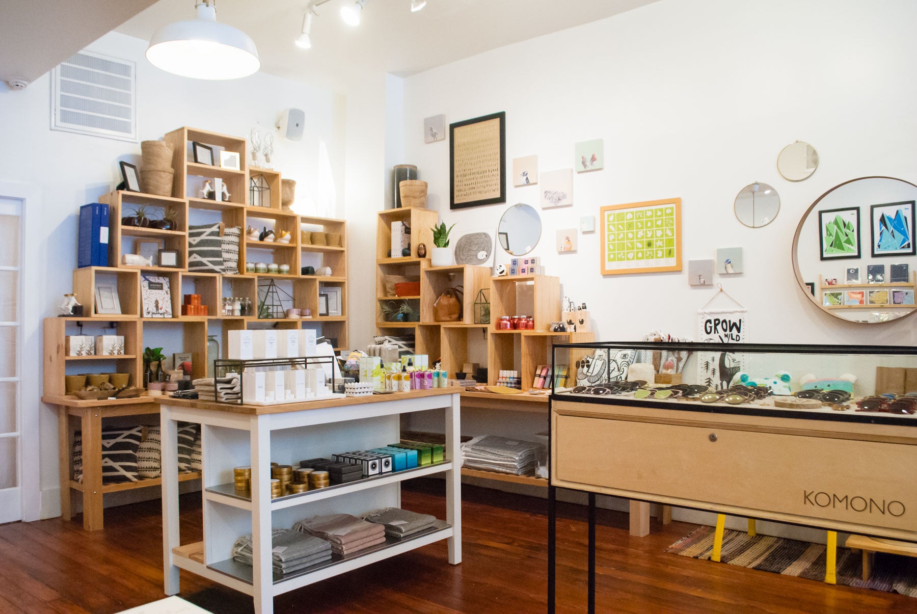 Personal accessories, home goods, and plant-based apothecary selects gather towards the back of the shop