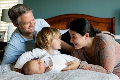 Family with new sibling baby