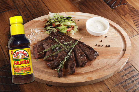 Claude's Sauces Fajita Marinade and a skirt steak sliced into edible pieces