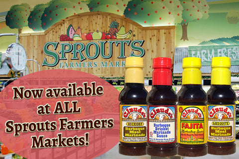 Claude's brand of sauces in bottles over a Sprouts store logo