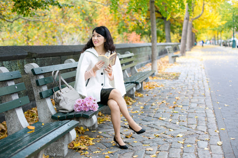 Ariel Tian, founder of Yun Boutique, reading in Central Park. (Photo by Samira Bouaou.)