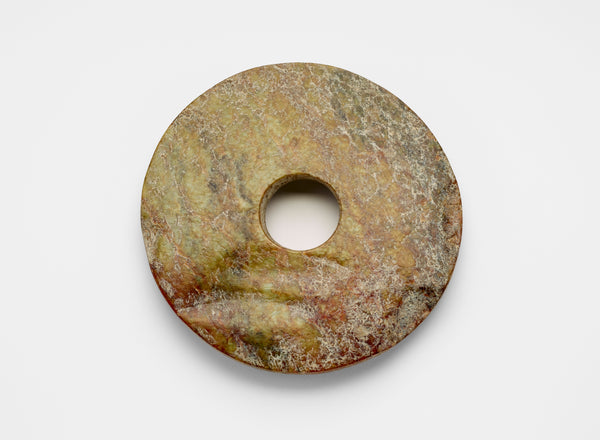Nephrite jade bi, late Neolithic period, ca. 3300-2250 BCE. (Freer Gallery of Art)