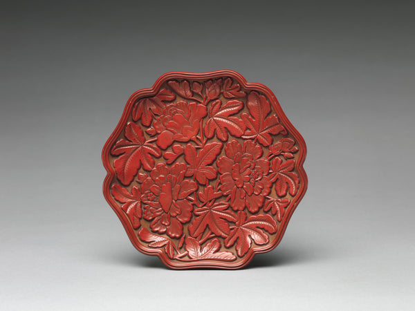 A dish of carved red (cinnabar) lacquer from the Yuan dynasty (1271–1368).  (Metropolitan Museum of Art)