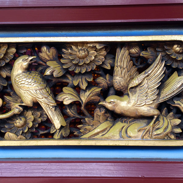 Birds frolic among plants on a gilt door panel. (Christine Lin/Yun Boutique)