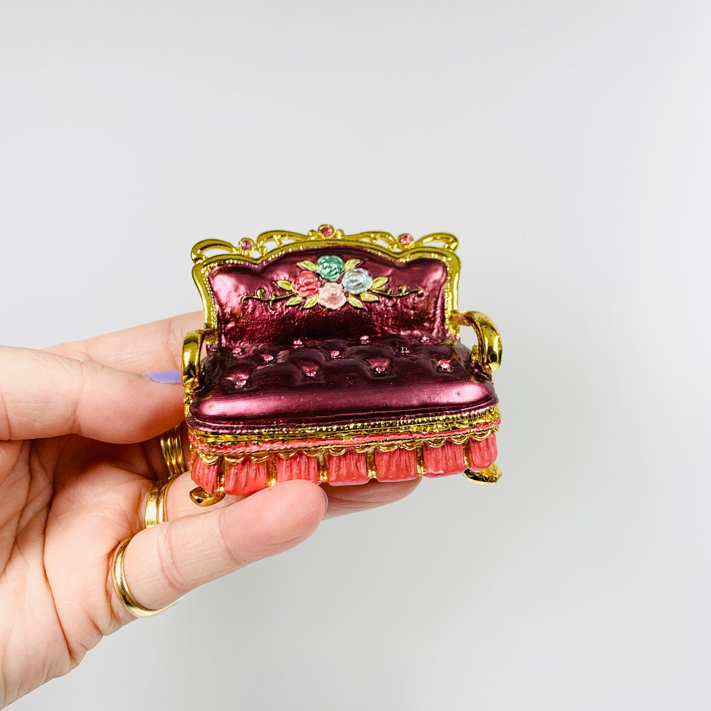 Vintage red enamel metal pill box in the shape of a divan