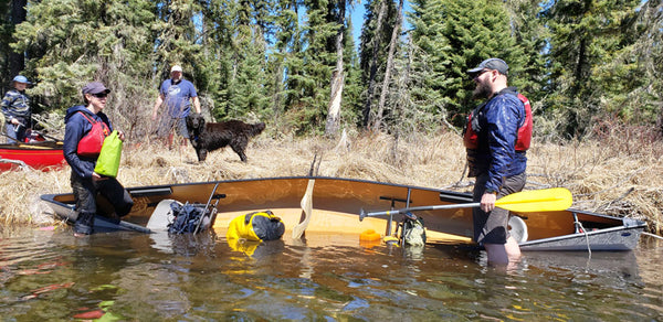 Couple with dumped canoe 