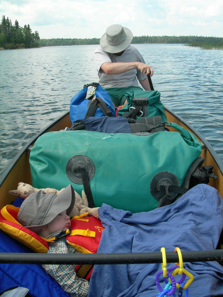 baby sleeping in canoe