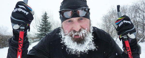 Frosty bearded guy cross country skiing in the cold 