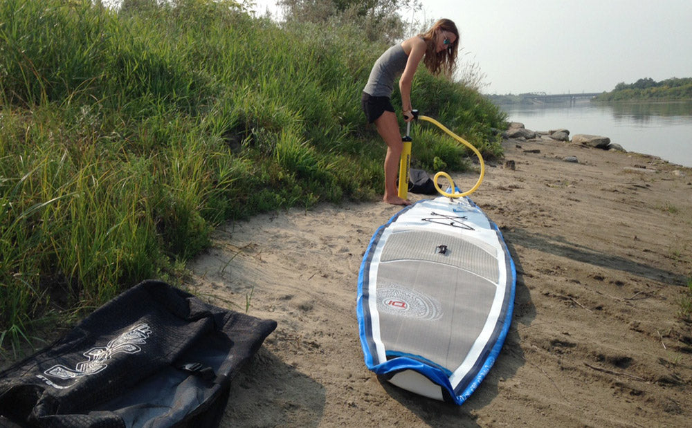 pumping up an inflatable SUP 