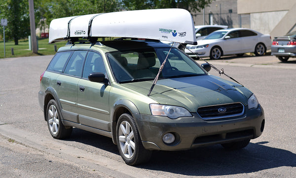 canoe tied onto car