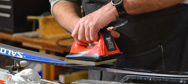 ironing in glide wax on cross country ski