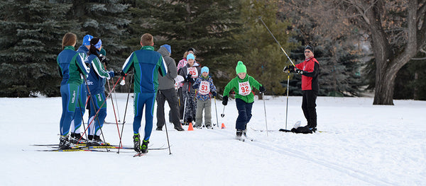 Ski racers watching kids cross country ski