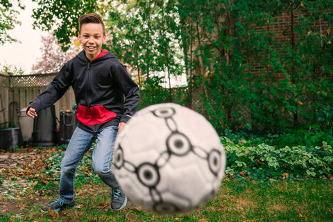 A kid catching a soccer ball