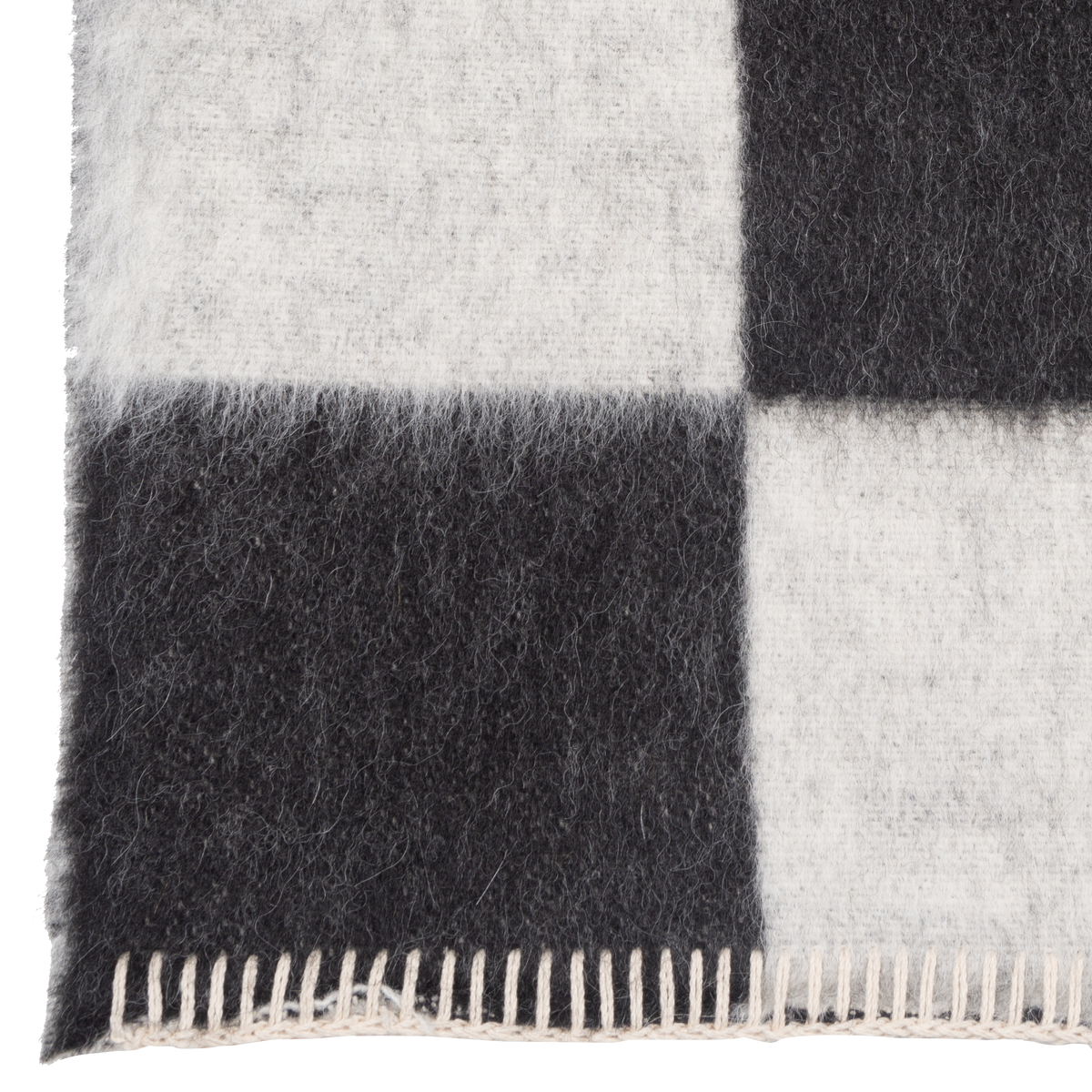 Presenting a luxuriously soft texture, the Crosby Check Throw is woven with natural superfine alpaca wool and undyed Peruvian cotton.