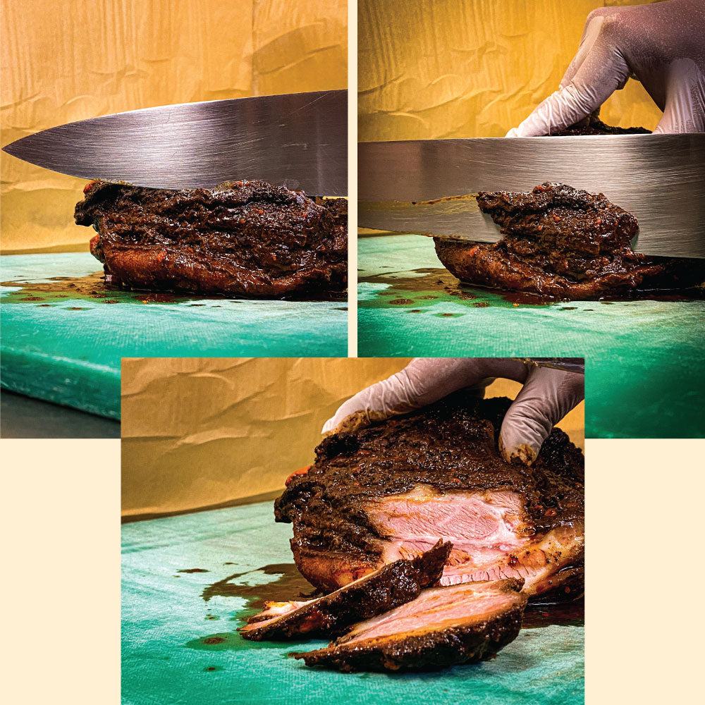 A knife going through different slabs of meat. 