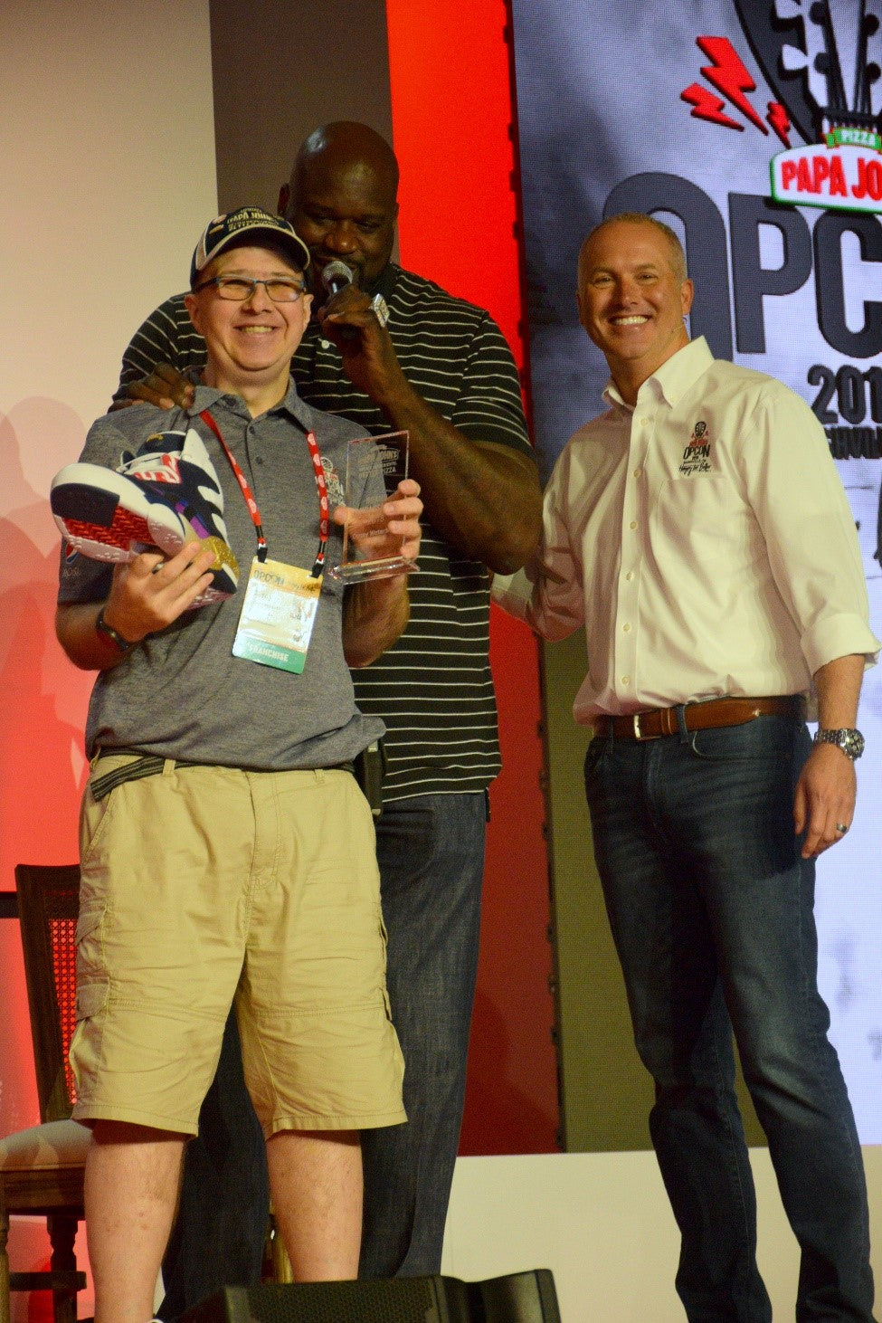 Casey proudly displays his National Brand Ambassador Award and the shoe signed by Shaquille O'Neal!