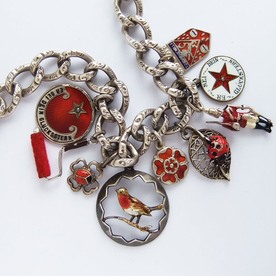 A collection of red themed antique and vintage bracelet charms | Silver Star Charms