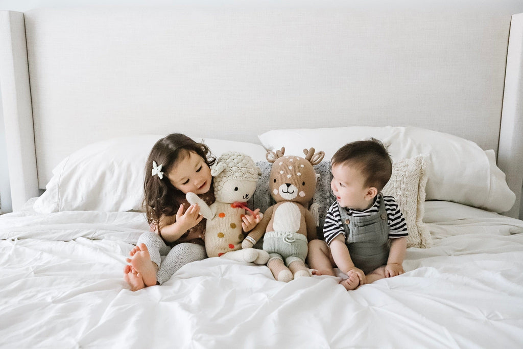 child playing with stuffed animals