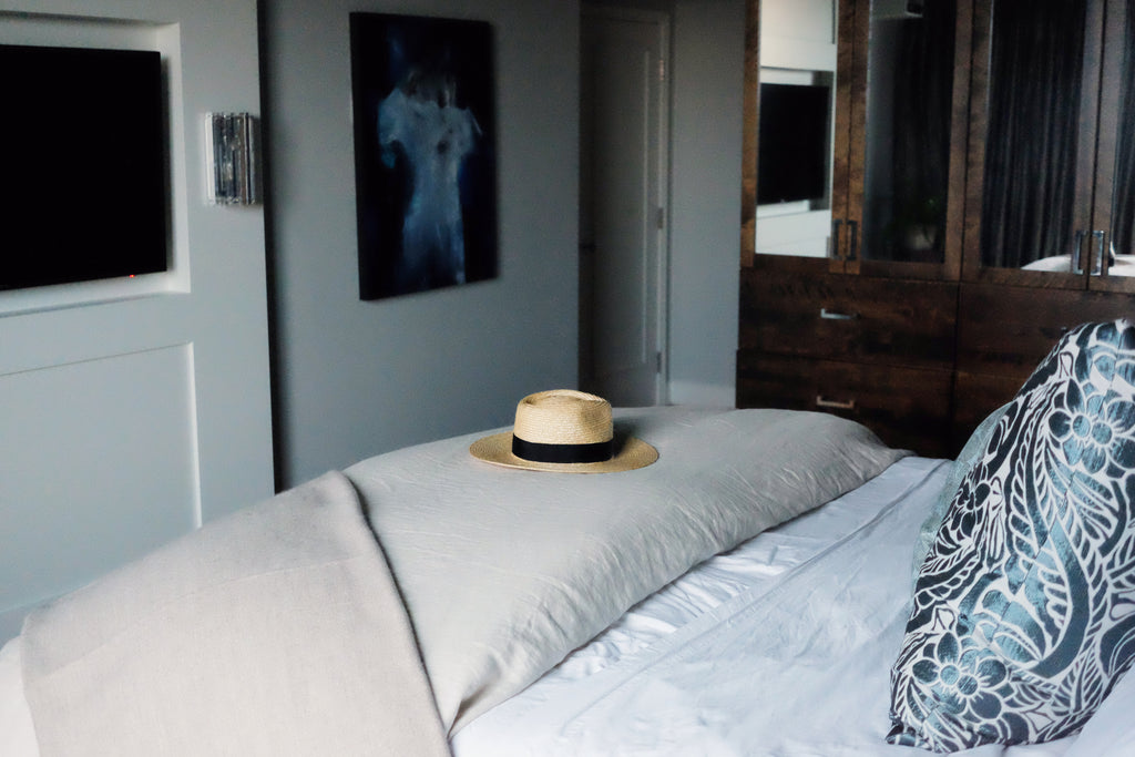 Master bedroom - bed foot with straw hat