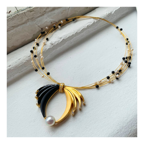 Condor necklace in sterling silver and 14k yellow gold with a 37.52 ct. black onyx, a white South Sea pearl, 17.01 cts. t.w. black onyx beads, white freshwater pearls, and 1.10 cts. t.w. diamonds by Brenda Smith Jewelry