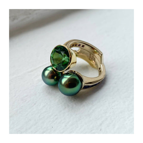 Ring in 18k white and yellow gold with a 3.81 ct. green tourmaline and two 2–8 mm cultured Tahitian pearls with 1.52 cts. t.w. sapphires and 0.40 ct. t.w. tsavorite garnets by Lara Alexander of FWM Jewelry