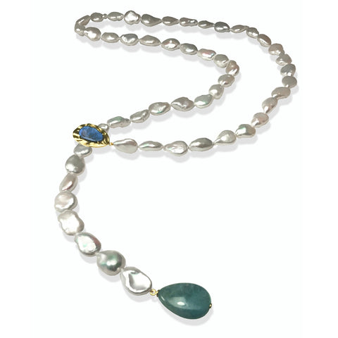 Tresa lariat in 14k yellow gold with white freshwater keshi pearls, a 26 ct. teardrop labradorite, and a 3.98 ct. lapis, $1,560; K. Mita