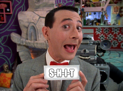 Peewee Herman holding sign that says "Shit".