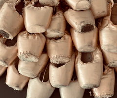 Photo of a pile of worn, dead pointe shoes 