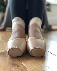 a pair of darned pointe shoes 