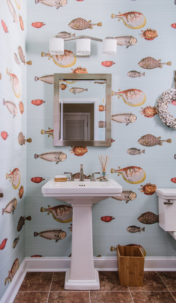 Powder room designed by Jamie Merida - fish wallpaper and pedestal sink