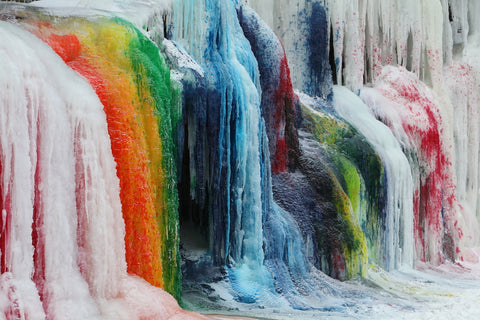 Frozen colored waterfalls in Glacier National Park during winter