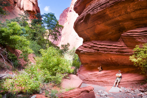 Hikers resting along Taylor Creek Trail in Kolob Canyons at Zion National Park in Utah, USA