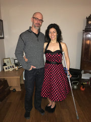 My fellow and me in my 50s dress, and my crutch on party night