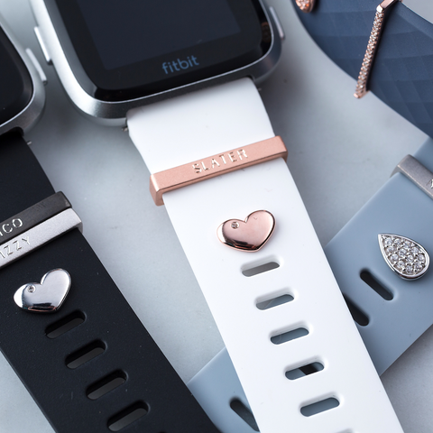 Pictured here: heart studs in silver and rose gold with a teardrop stud in silver for Fitbit Versa