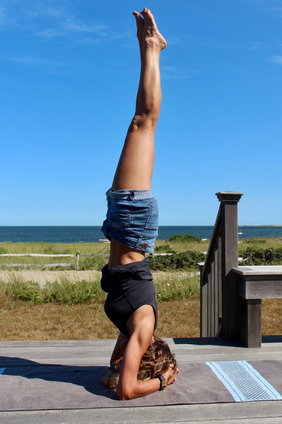 Jodi doing headstand with OM slide for Fitbit Charge HR