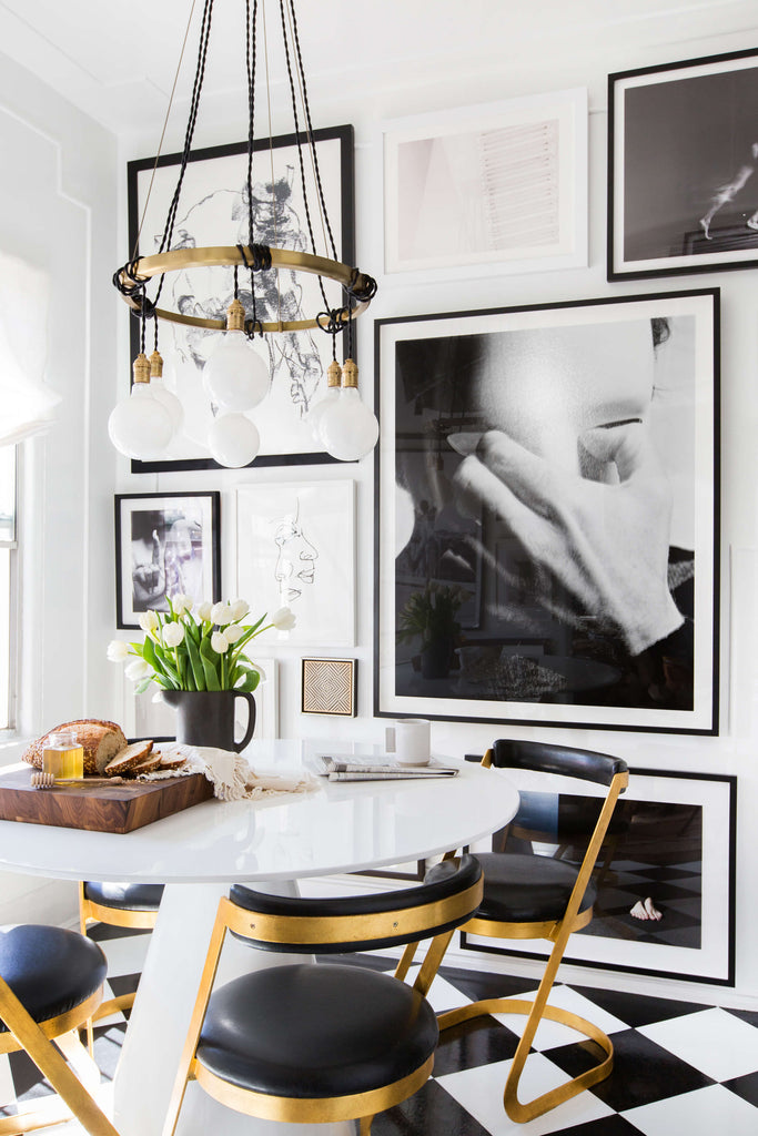 Kitchen with chandelier and black and white checkered floor.