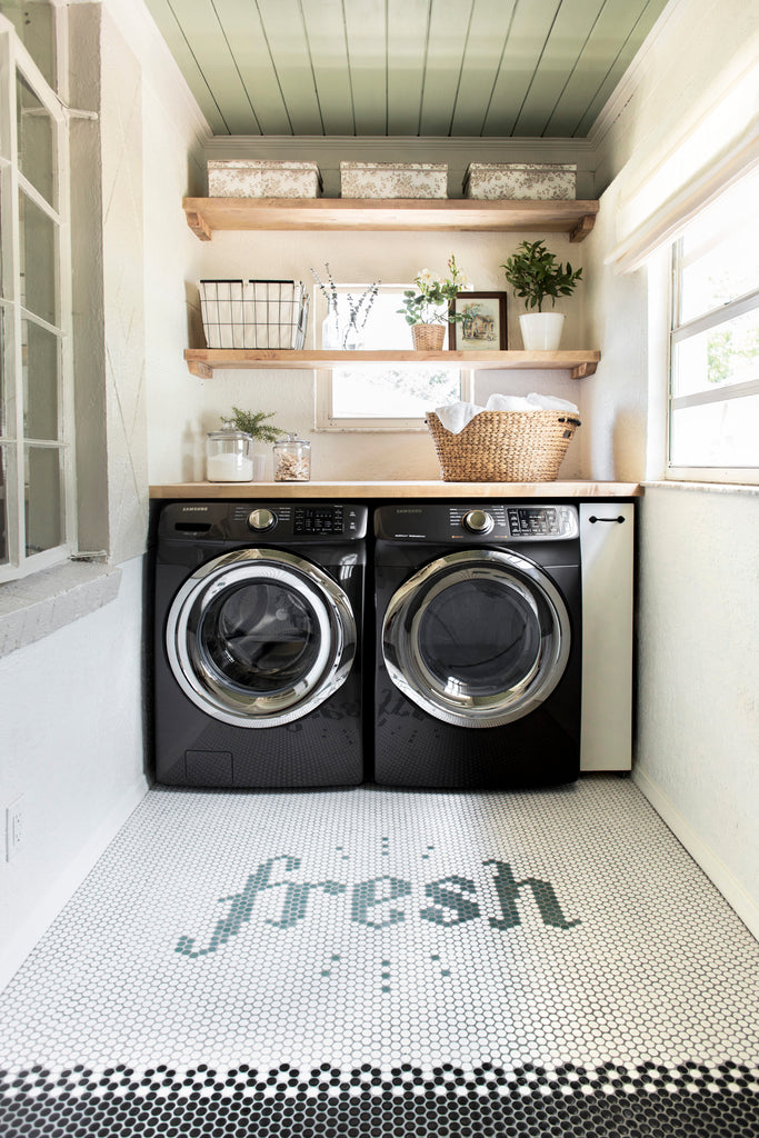 Jenna Sue Design laundry room with open shelves and tile floor