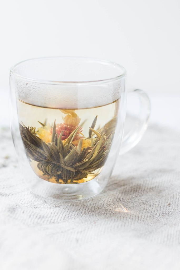 Clear insulated tea cup with herbal tea in it