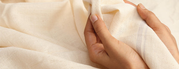 hands touching Karunganni organic desi cotton towel