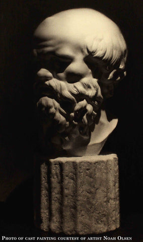 Photo of cast drawing of Socrates bust on a black background
