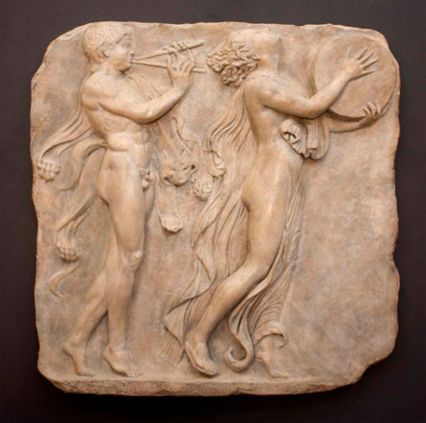 Photo of plaster sculpture relief of Bacchic Dance, male and female dancing and playing music