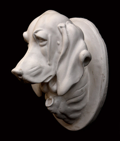 Photo of a plaster cast original Caproni sculpture of a portrait head of a pointer dog on a black background